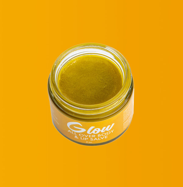 Close up image of open jar of Glow all over body and lip salve.